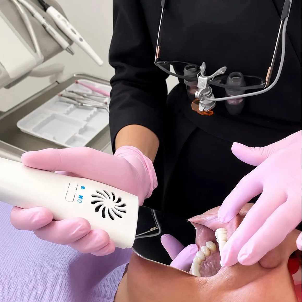 Dentist using the anti-fog mirror chairside on a patient.