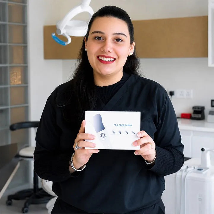 Dentist holding the Anti-Fog Mirror System box.