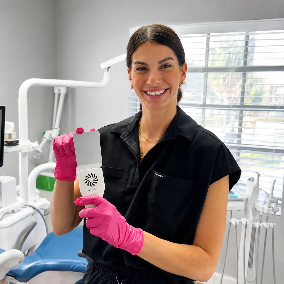 Dentist holding the anti-fog mirror handle with mirror attached.