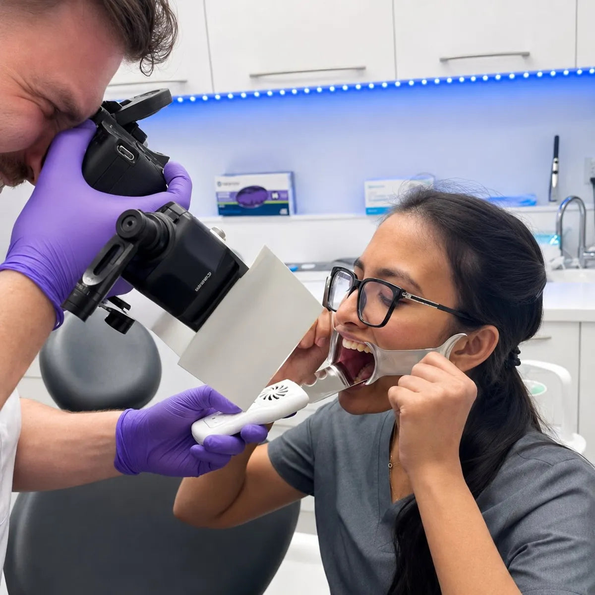 Dentist taking DSLR intraoral photos using the anti-fog mirror.