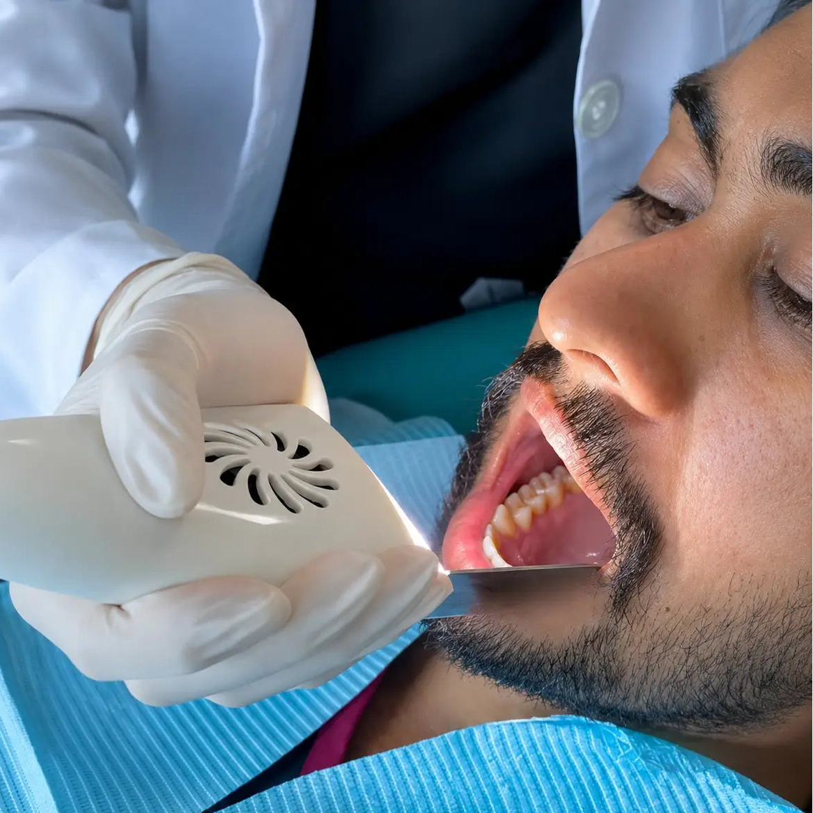 Anti-fog mirror reflecting a lingual view of a patient's teeth.