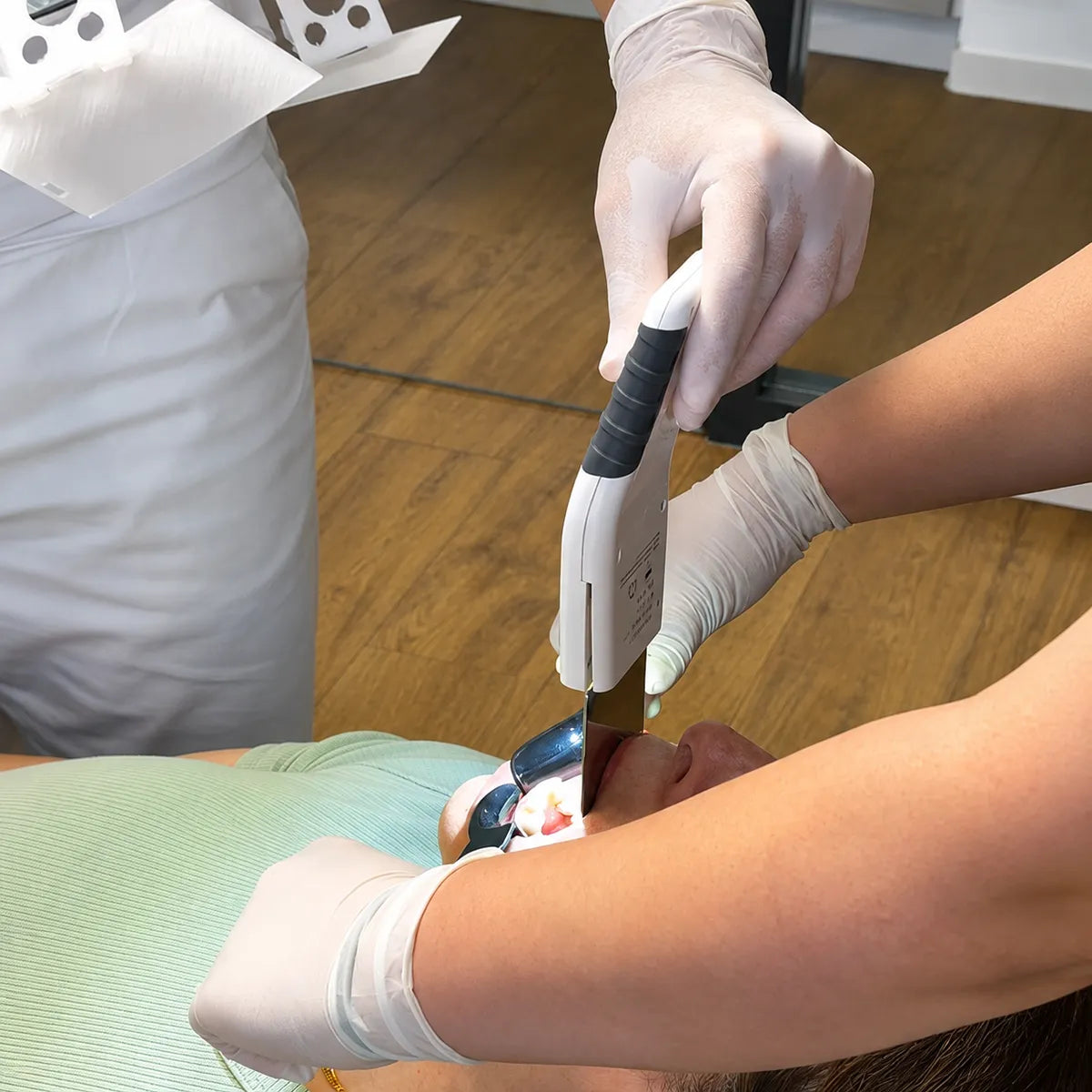 Dentist using the Anti-Fog Mirror Pro on a patient.