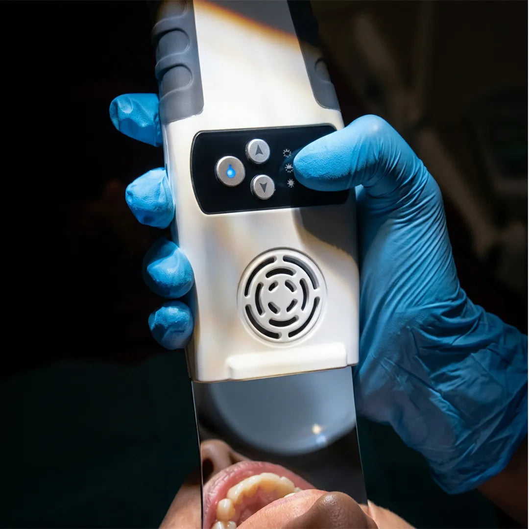 Anti-Fog Mirror Pro held by a dentist during dental photography.
