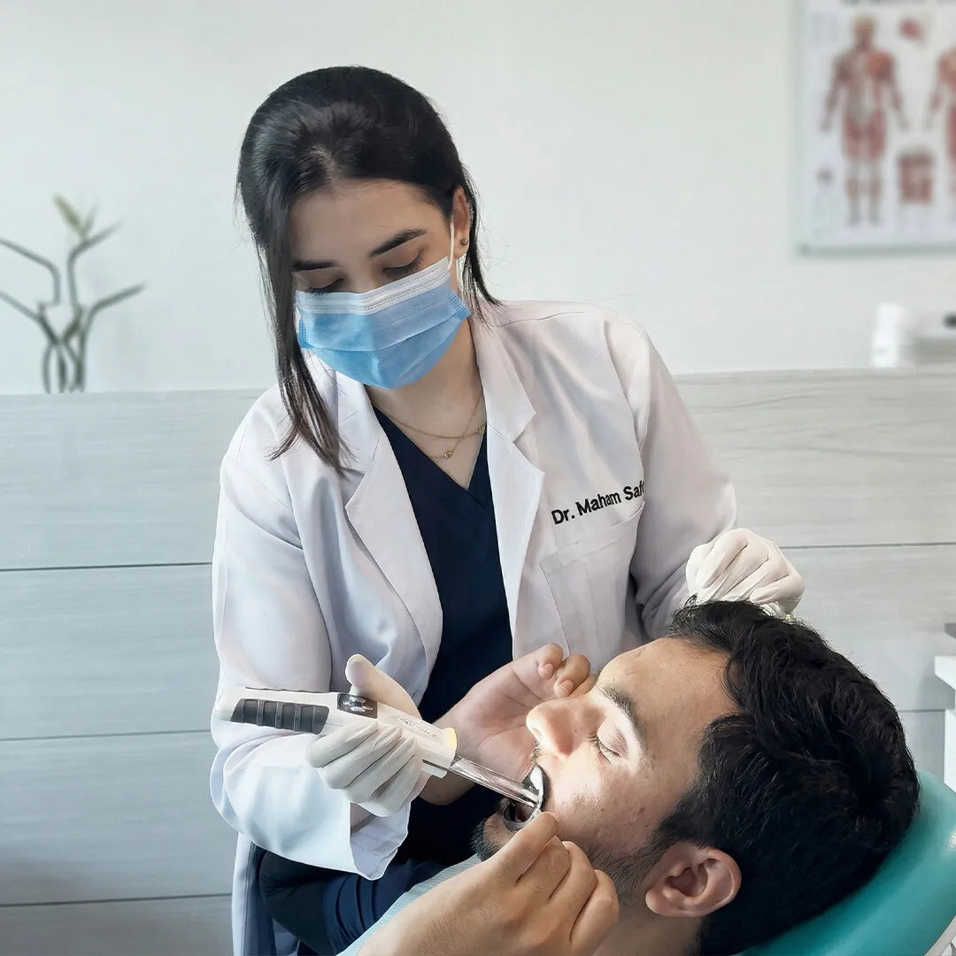Dentist using the Anti-Fog Mirror Pro on a patient.