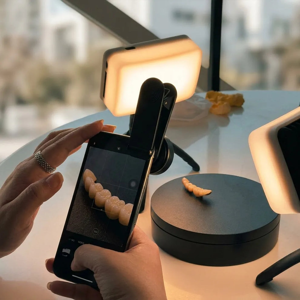 Photographing a dental crown on a turntable with a macro lens and phone.