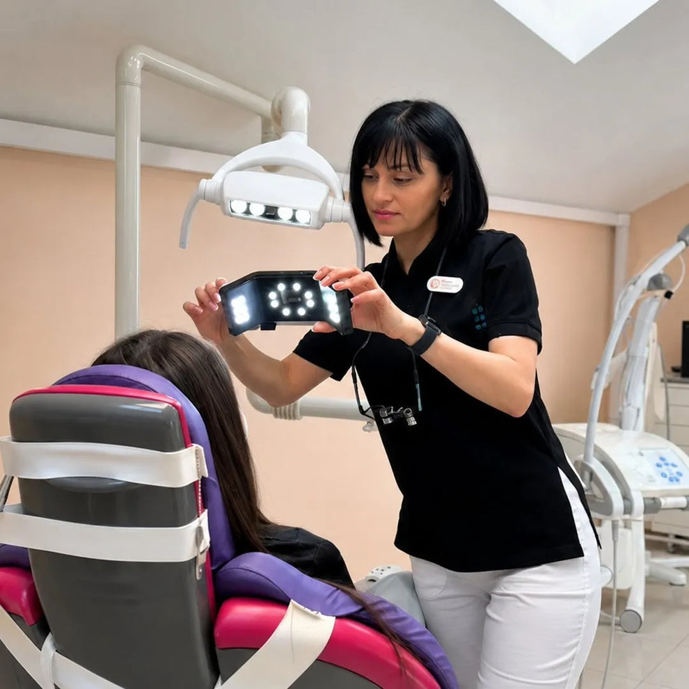 Dentist taking a dental photo of a patient with a photography light.