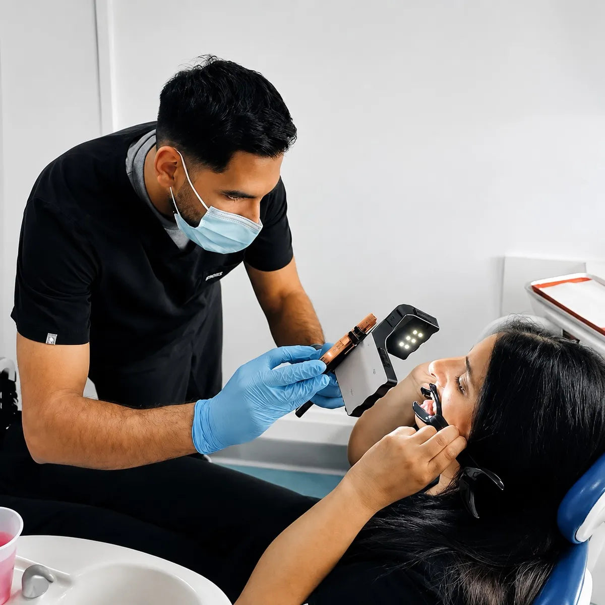 Dentist taking dental photos of a patient with the Dental Kits photography light.