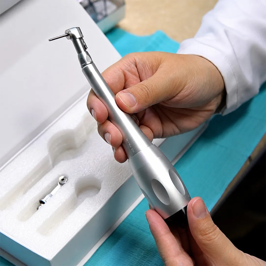 Dentist holding a dental implant torque wrench.