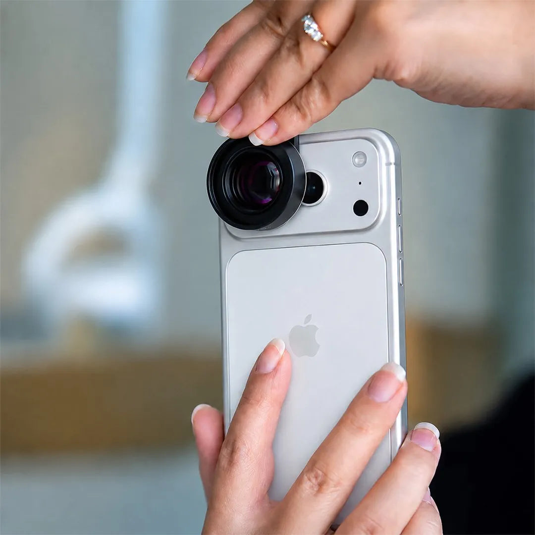 Macro lens being attached to a phone for dental photography.