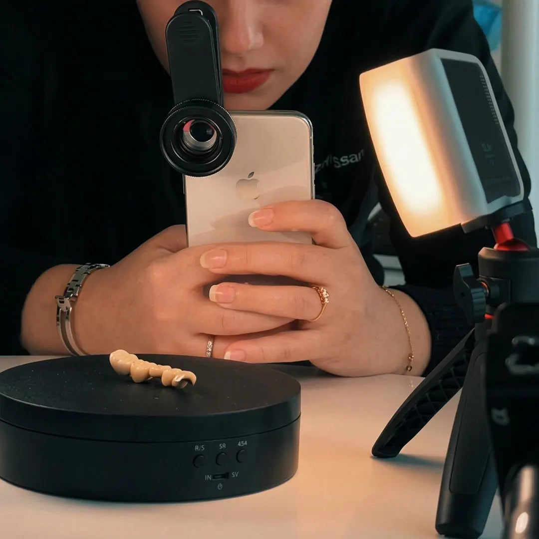 Dental technician photographing a crown with a macro lens and turntable.