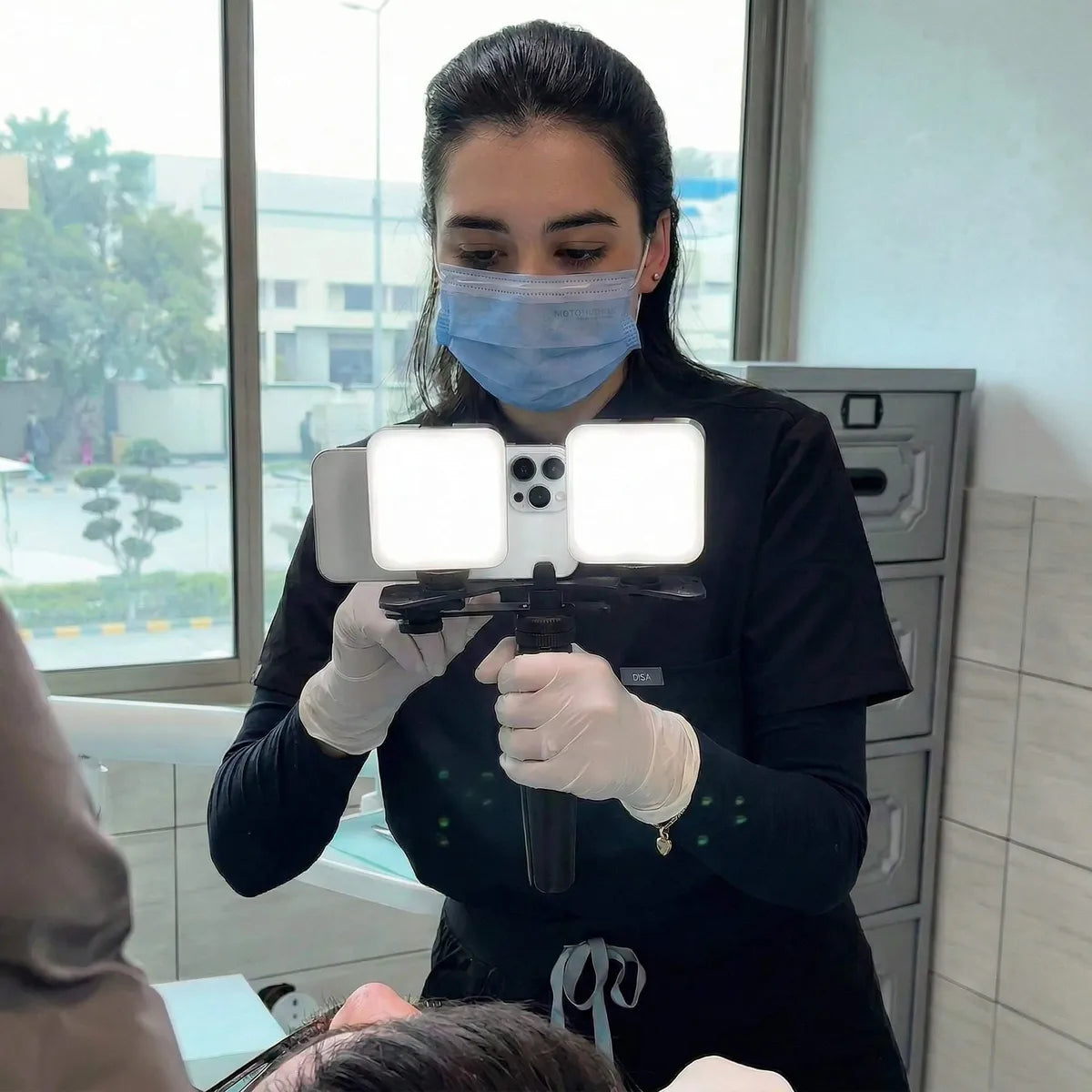 Dentist photographing a patient with the Dental Twin Light with Tripod.