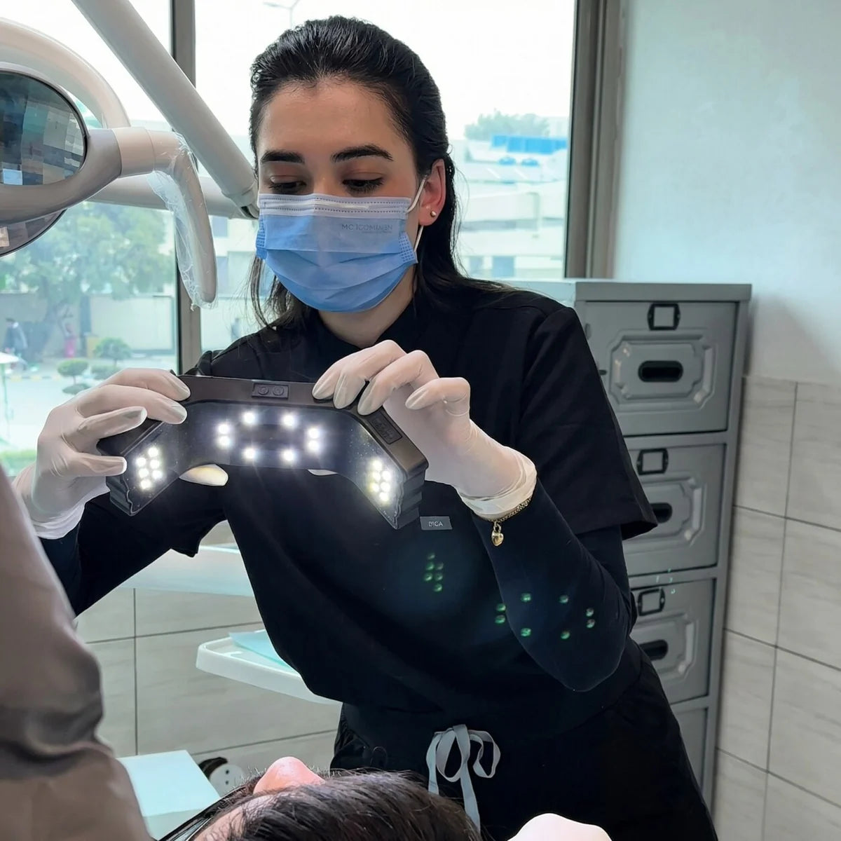 Dentist taking intraoral photos with dental photography light