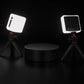 Two LED lights on tripods with a rotating base on a dark background.