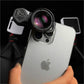 Macro lens clipped onto a smartphone with LED lights in the background.