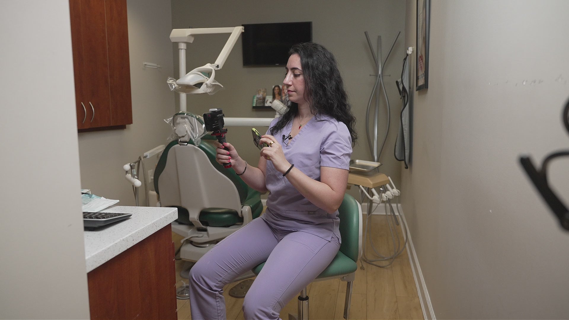 Dentist photographing a patient's teeth chairside using Twin Light and a smartphone