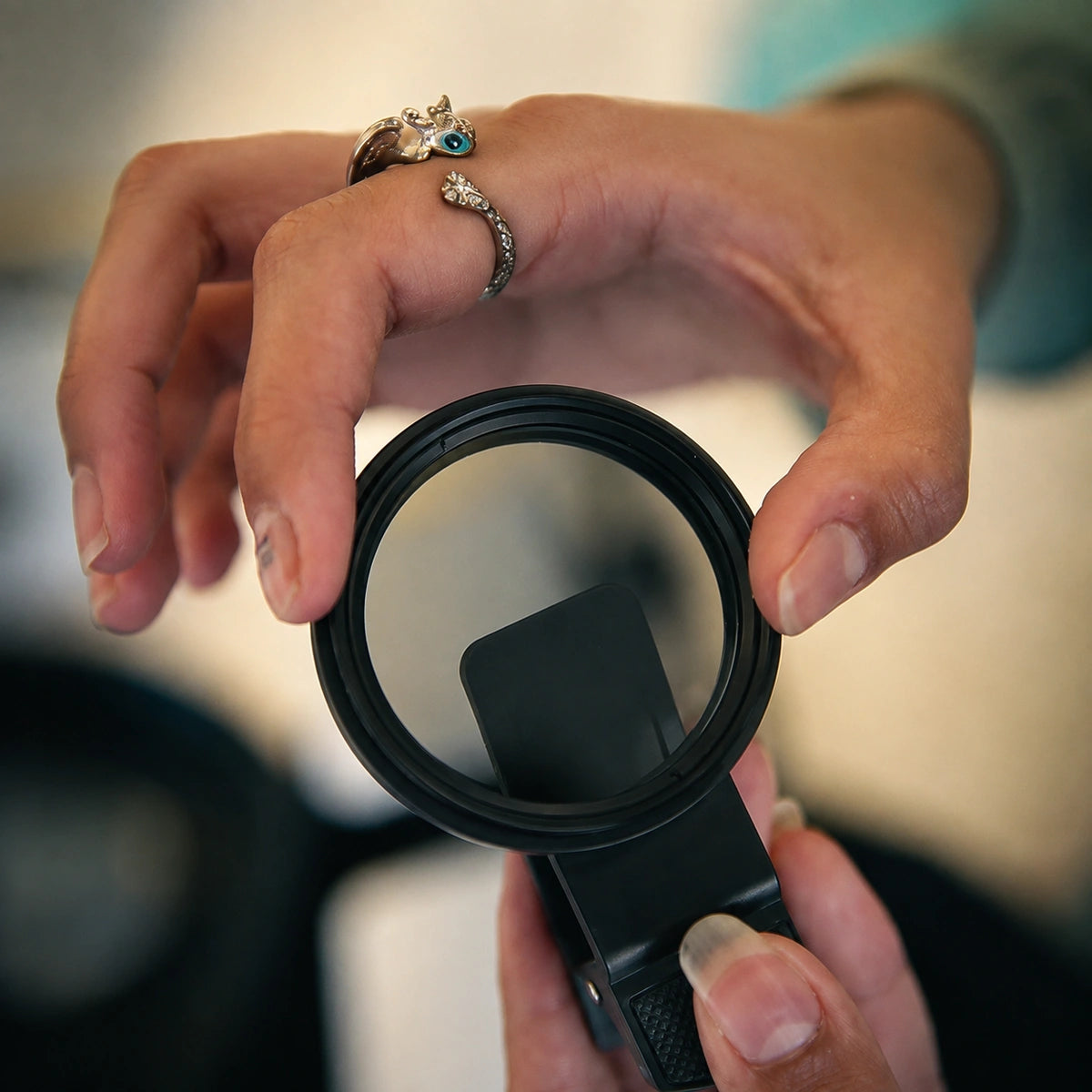 CPL filter for dental photography held in hand close-up.